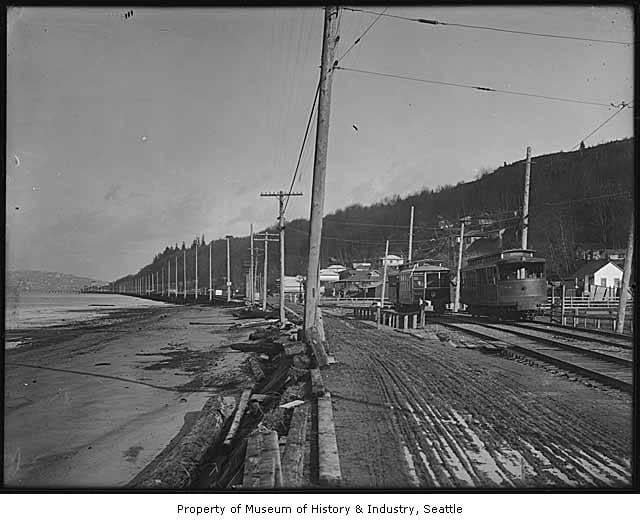 Alki Beach circa 1911 before the sand and before Alki Avenue, at about today’s 55th Avenue, about where the volleyball court is located: