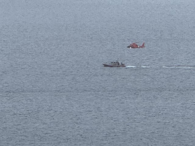 Coast Guard helicopter really low and following a boat