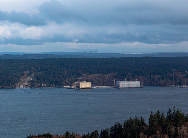 Nuclear missile loading wharves of Bangor Naval Base with the Seattle skyline in the distance