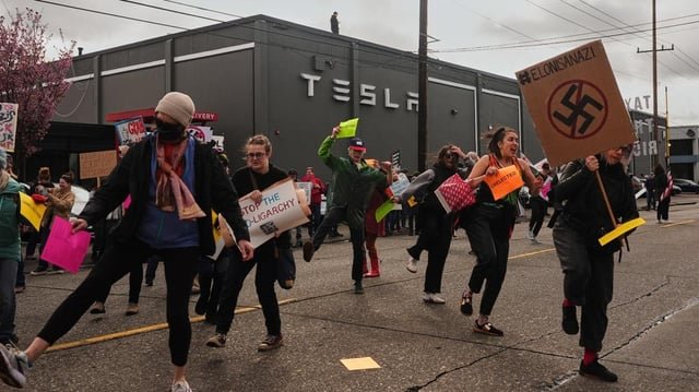 Hundreds protest outside Seattle-area Tesla dealerships Saturday as part of worldwide movement
