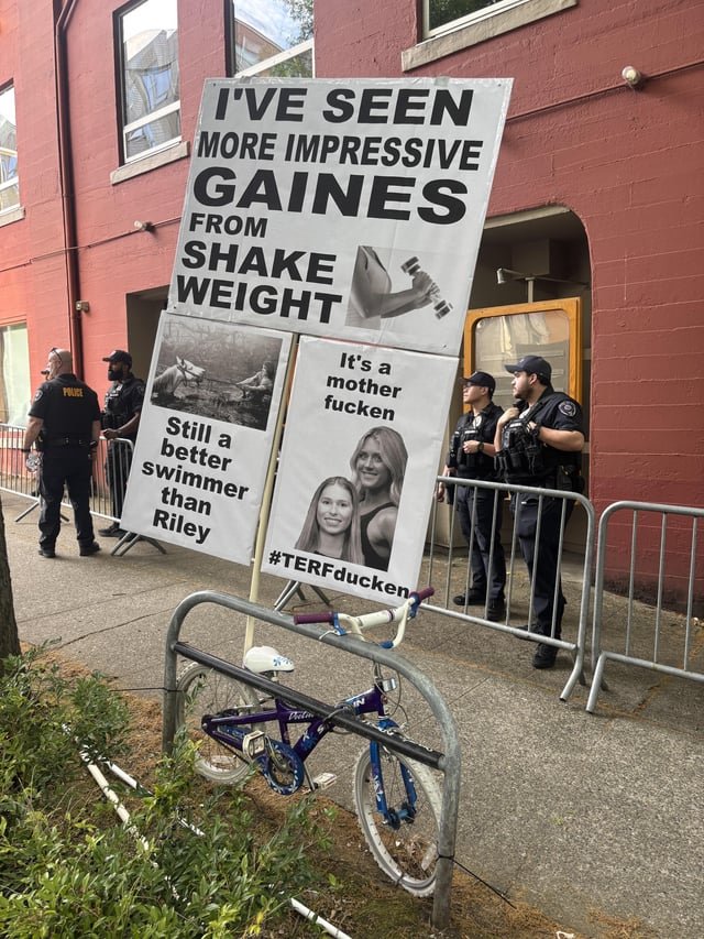 It would be illegal to attach protest signs to the bike rack at the transphobic Riley Gaines / Olivia Krolczyk event