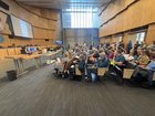 Packed city council meeting with speakers giving opposing views on density plan