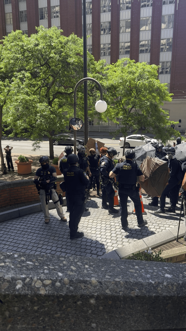 Rally Update: Entrances and exits have been barricaded with Lime scooters, which means ICE vans cannot leave the federal building.