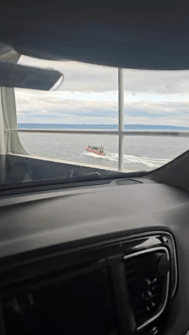 Coast guard escorting the Seattle Ferry with a big gun
