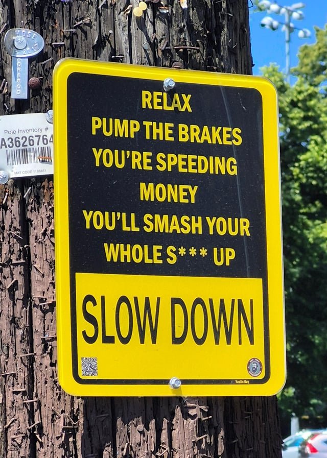 I’ve seen some creative “Slow Down” signs before, but this is just weird.