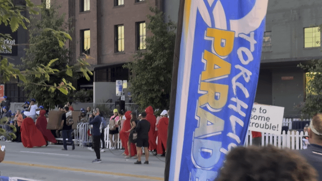 Good Trouble crashes SeaFair parade with Handmaid’s Tale outfits and Defund Musk” and “Make Atwood Fiction Again” signs