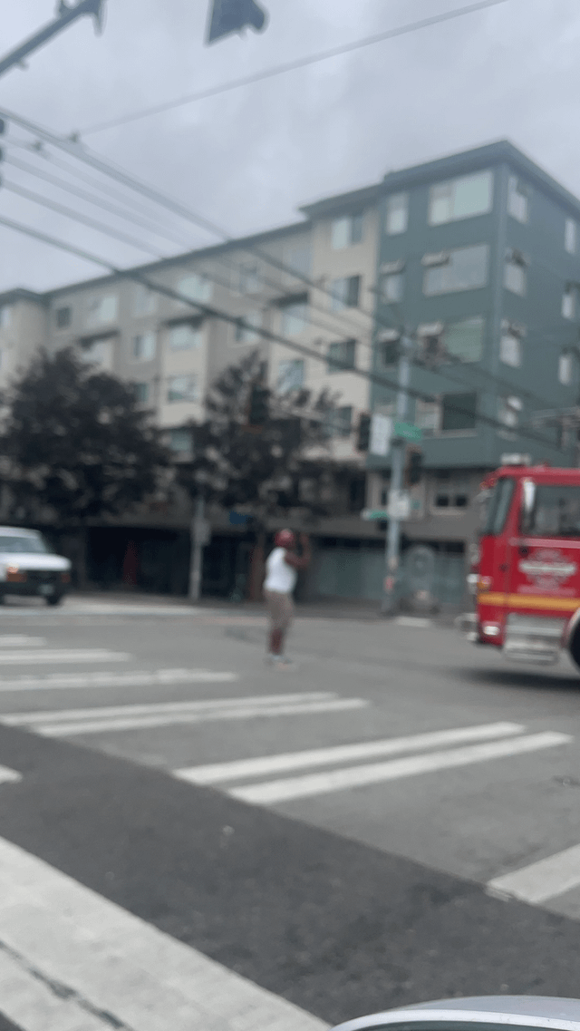 Man stands in front of fire truck cussing out