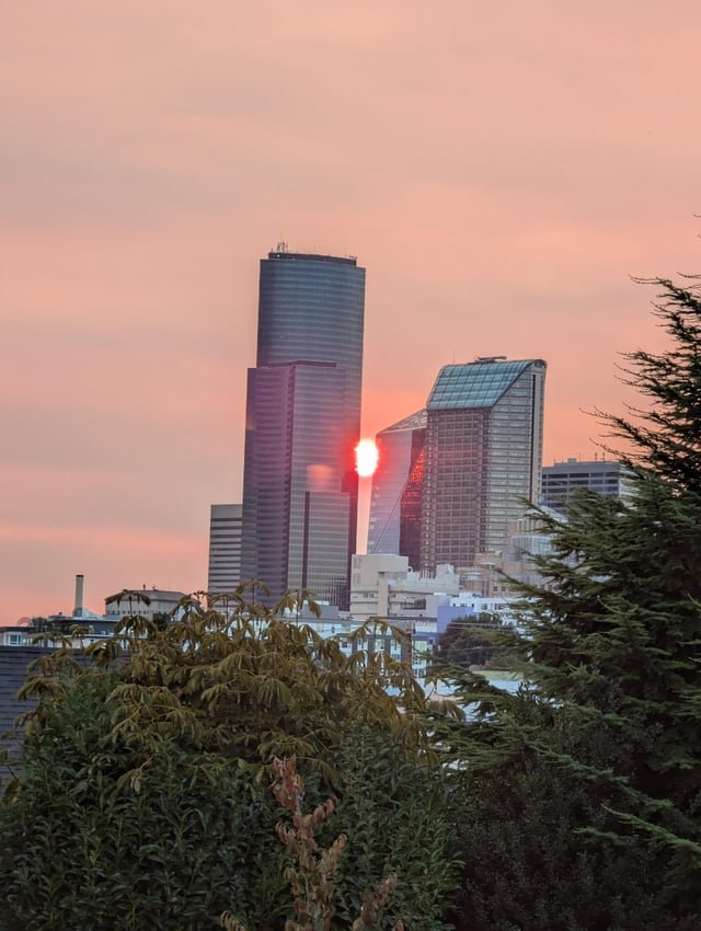 Smoky sunset between downtown skyscrapers 8/12/2025