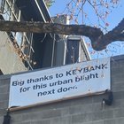 Banner on building south of abandoned Key Bank thanking them for the “urban blight”