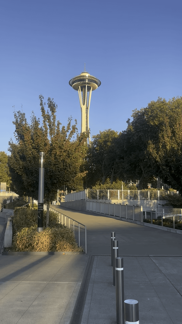 From one place on the ground, around sunset, you can see the waves of Puget Sound reflected in the angled glass of the Space Needle