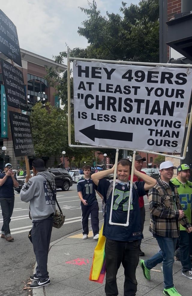 49ers-Seahawks game featuring running back Christian McAffrey and street preachers outside at 80 decibels