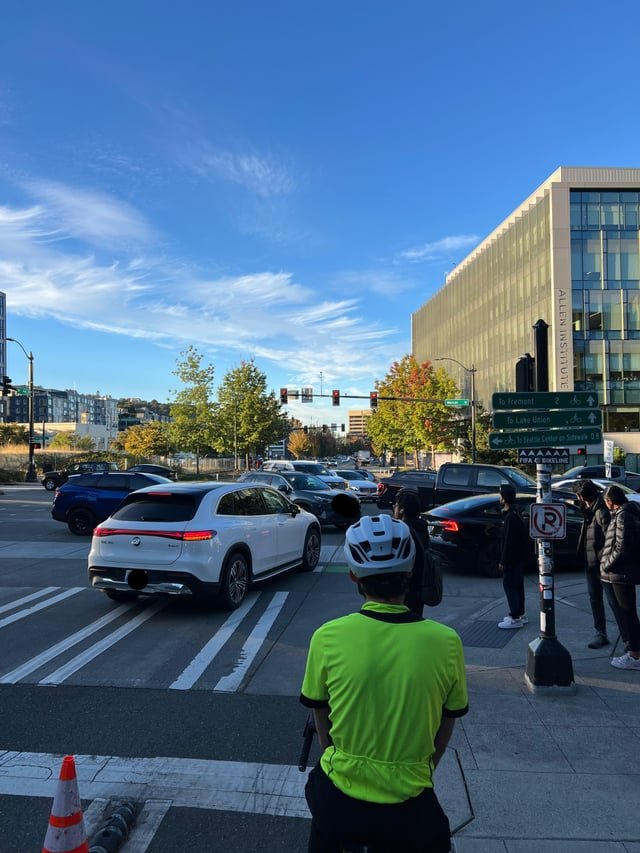 Every car in this photo is stopped, blocking the intersection