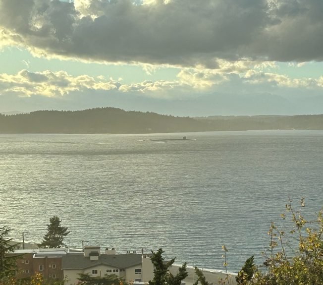SEEN FROM WEST SEATTLE: Submarine passing Alki; stadium rainbow
