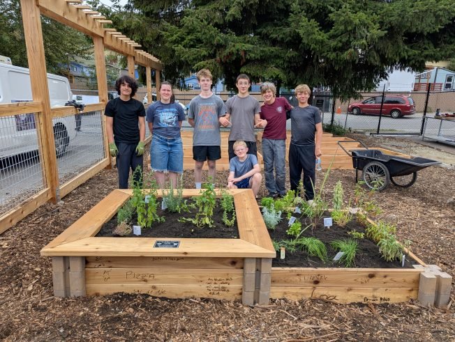 HELPING: Scouts from Troop 282 give food bank’s garden a boost