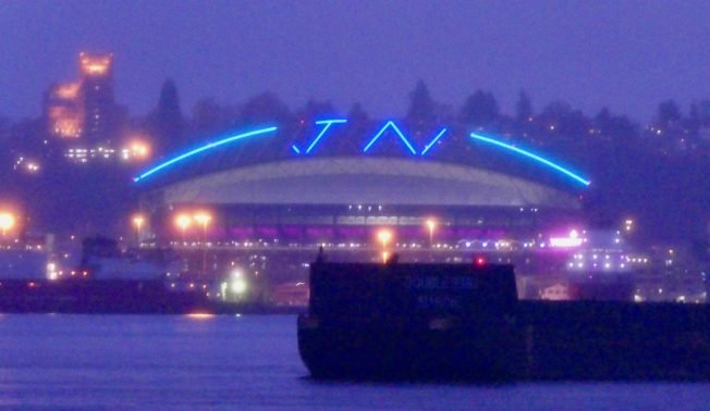 SEEN FROM WEST SEATTLE: Stadium roof lights up for a returning Mariners star