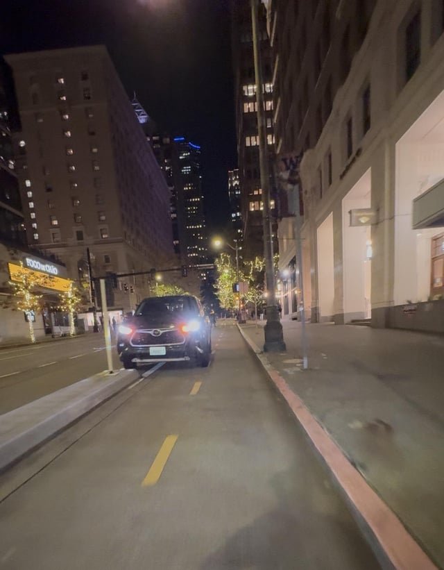 Why do all the free parking spots downtown have these dotted yellow lines and bike murals painted on them?