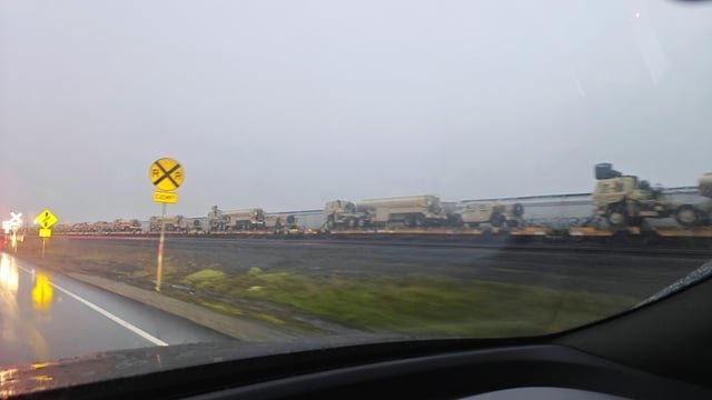 Tons of military trucks on a train today in Auburn