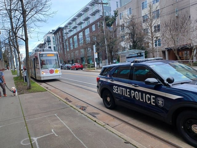 Streetcar is blocked by a vacant police car on the tracks!