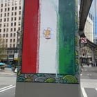 Iranian flag on monorail support column altered to turn it into the Lion and Sun flag