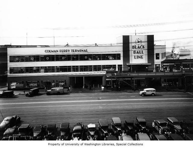 On today’s 75th anniversary of the State of Washington’s acquisition of the Black Ball Line, a look at Black Ball’s striking 1930s Art Deco ferry terminal, with the Silver Slug coming into dock in the background: