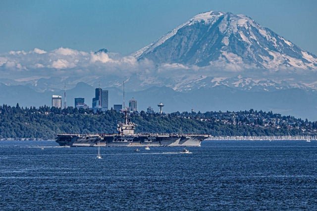 Great shot of the USS Theodore Roosevelt passing thru Seattle en route to Bremerton Naval Shipyard taken by Tim Davis.