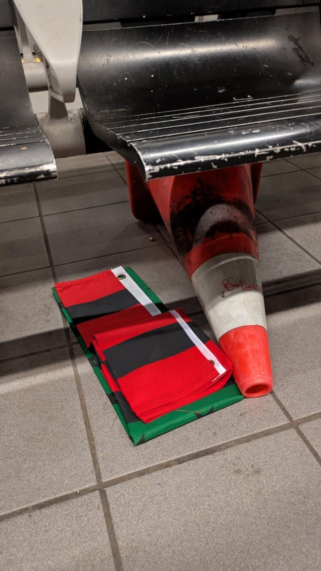 Flag at traffic cone left at Cap Hill station