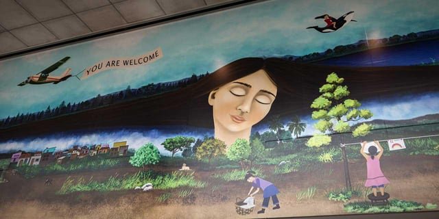 The “welcome to immigrants” mural that was removed from International Arrivals at Sea-Tac