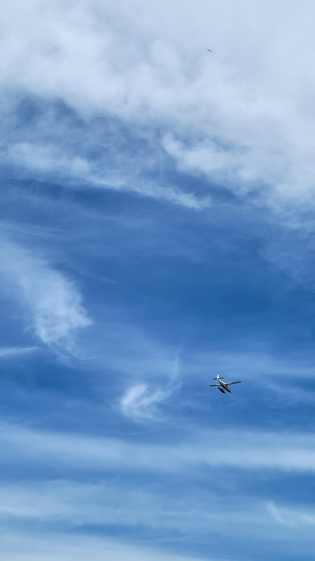 Some lovely clouds dotted with a seaplane, somewhere not far from SLU