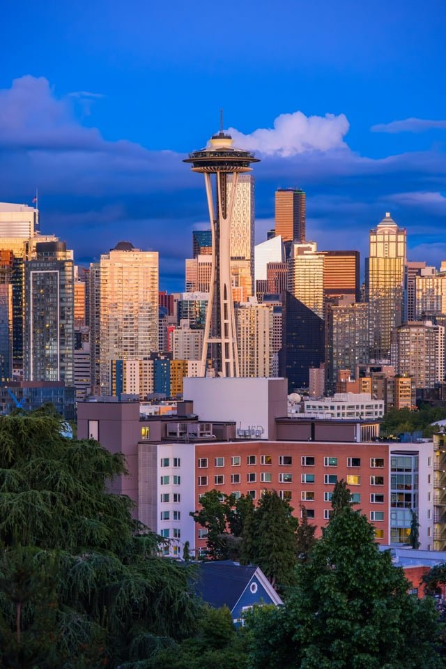 Seattle skyline with space needle at sunset under dramatic sky