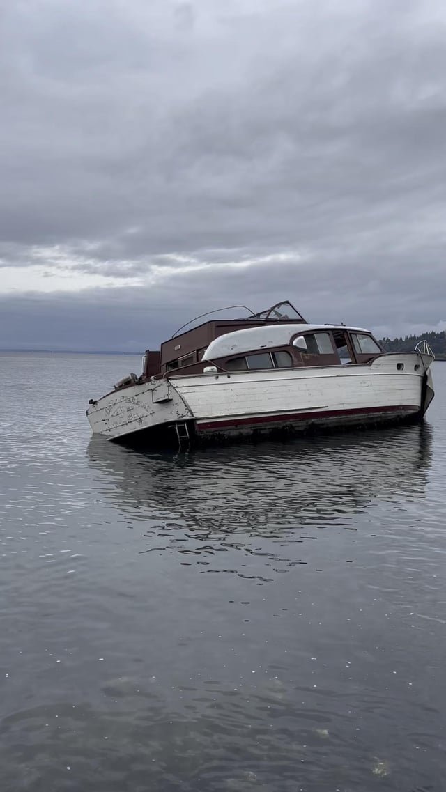 Low-tide view of boat run aground off of Discovery Park