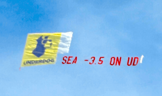 Underdog, the scummy sports-betting “prediction market” website that’s suing our state is flying a banner over Seattle today.