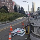 How can I get this pedestrian exit sign on I-5 @ Olive Way fixed? Almost got hit the other day.