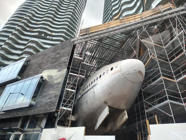 They use the old plane hatch to load stuff into the building; pretty interesting